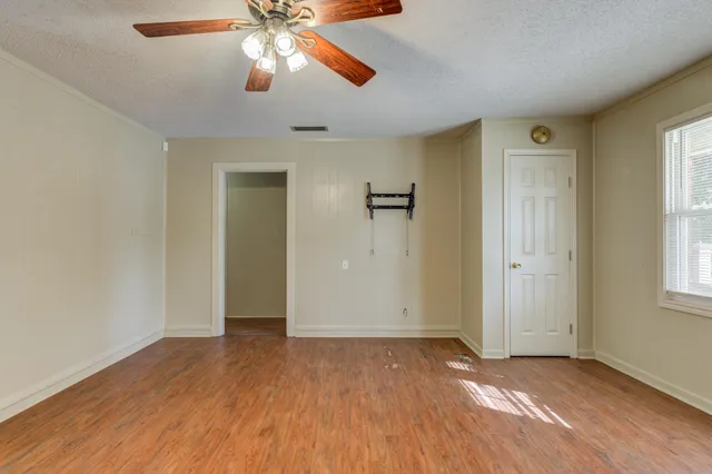 wooden floor in an empty room with a window