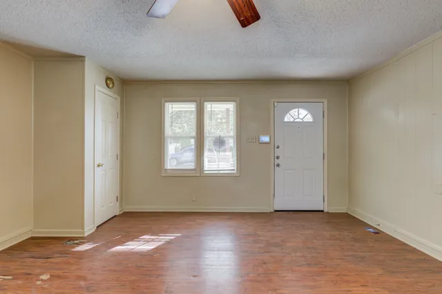 an empty room with windows and closet