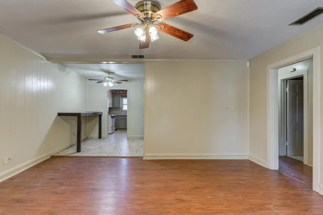 wooden floor in an empty room with a window