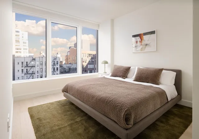 a bedroom with a large bed and a large window