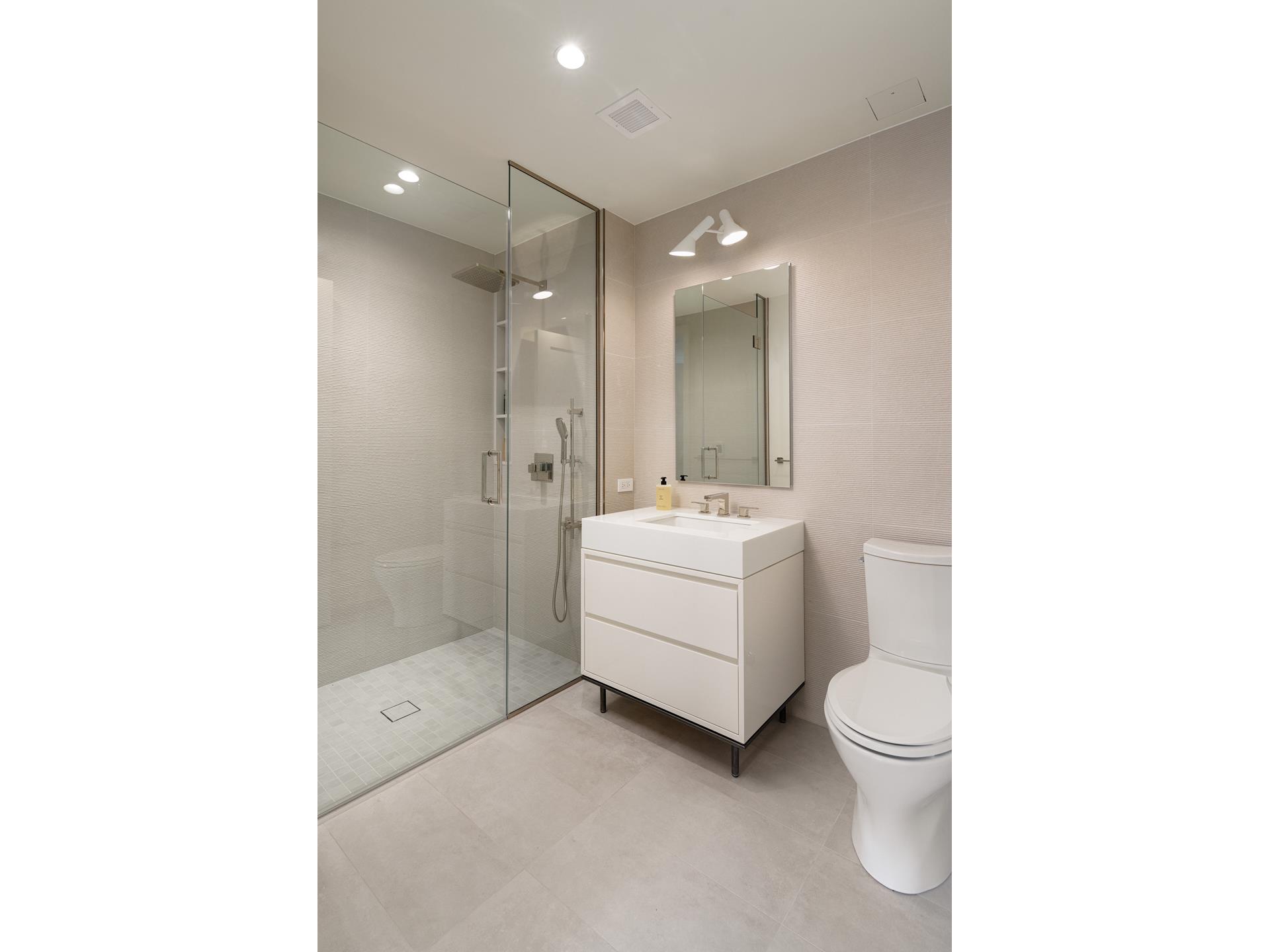 200 East 20th Street, Unit 5D Manhattan, NY 10003 - Photo 5 of 14 a bathroom with a sink toilet and shower