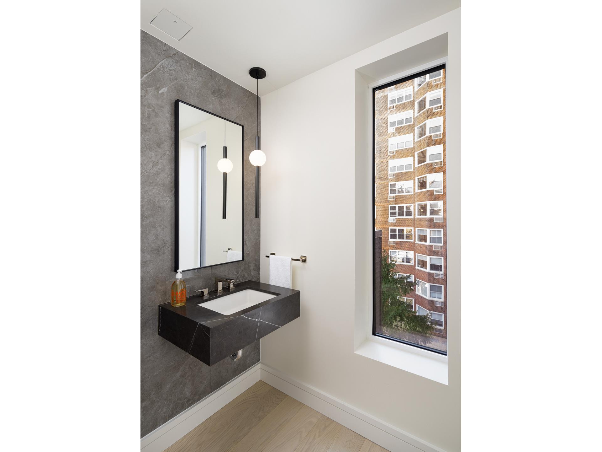 200 East 20th Street, Unit 5D Manhattan, NY 10003 - Photo 6 of 14 a bathroom with a sink and a mirror