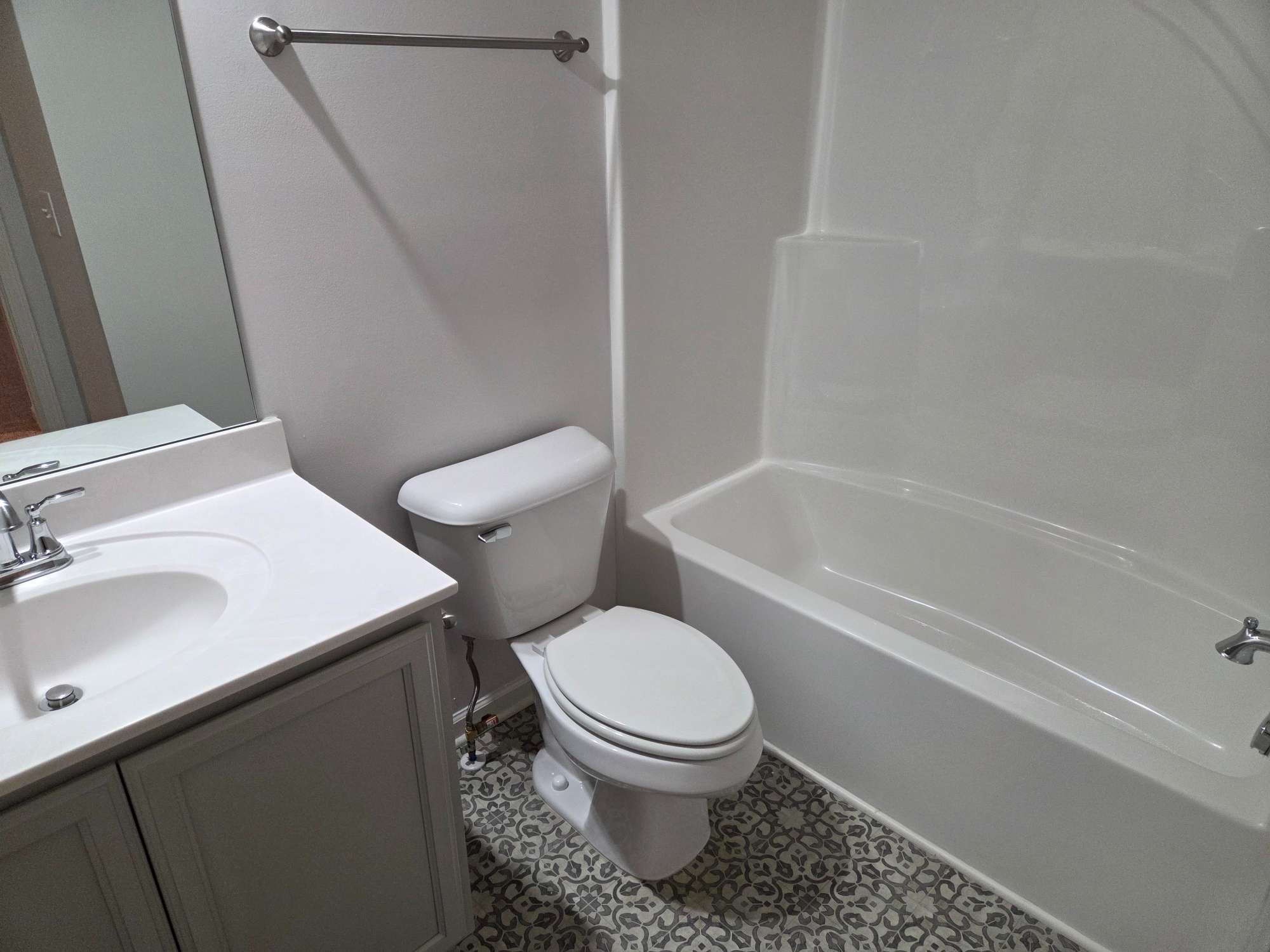 1709 Calypso Drive Murfreesboro, TN 37128 - Photo 14 of 16 a white toilet sitting next to a bathroom sink and tub