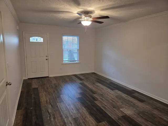 wooden floor in an empty room with a window
