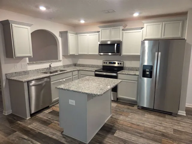 a view of a room with wooden floor and white walls