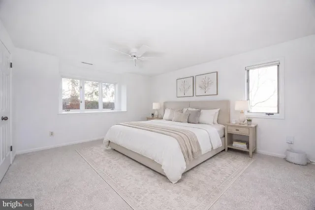 a spacious bedroom with a bed and a window