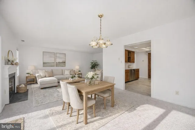 a dining room with furniture a rug and a chandelier