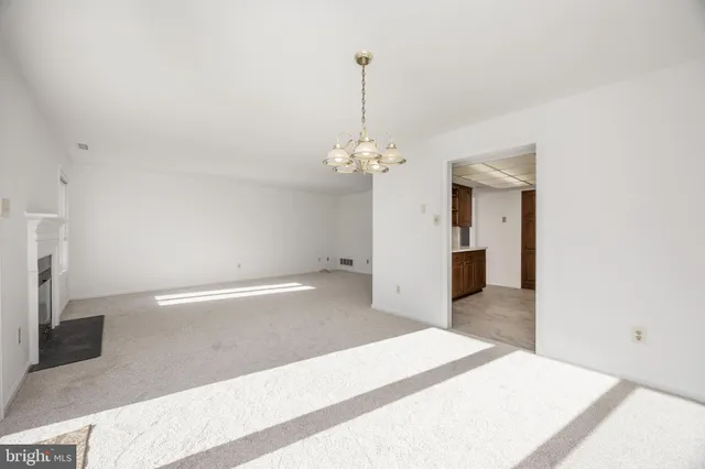 a very nice looking room with a large bed and a chandelier