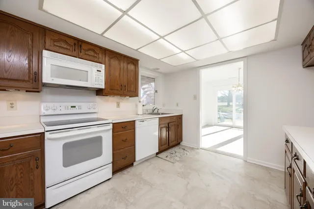 a kitchen with stainless steel appliances a stove sink and microwave