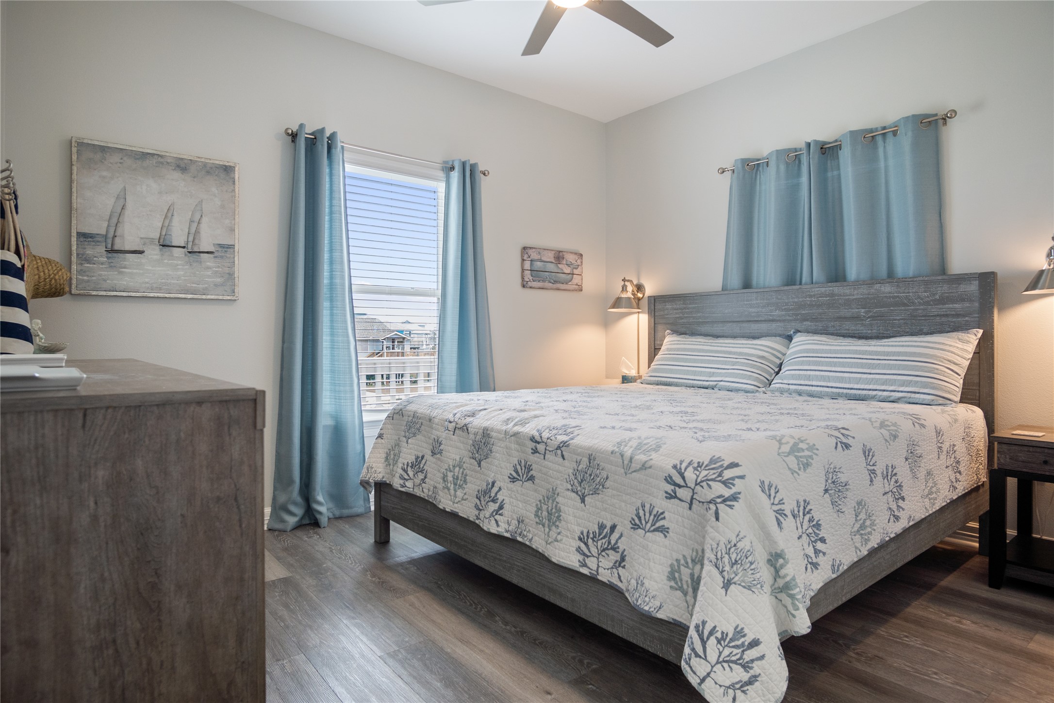 956 Biscayne Crystal Beach, TX 77650 - Photo 12 of 46 a bedroom with a bed and wooden floor