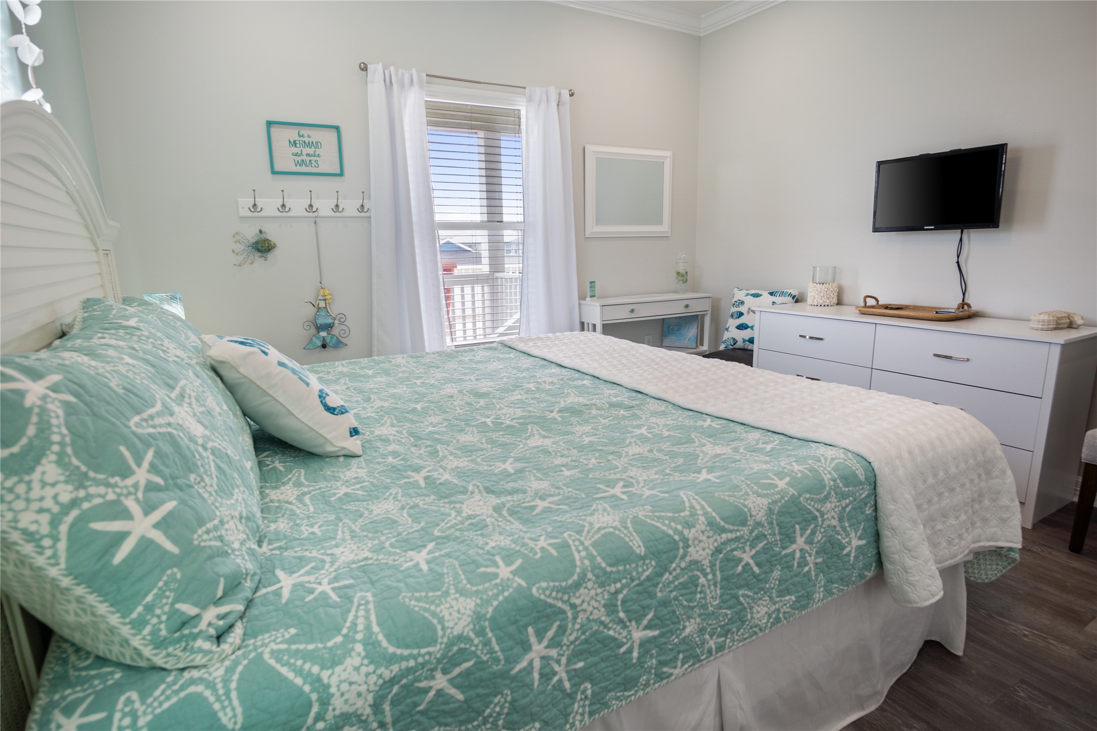 956 Biscayne Crystal Beach, TX 77650 - Photo 18 of 46 a bedroom with a bed and a flat screen tv