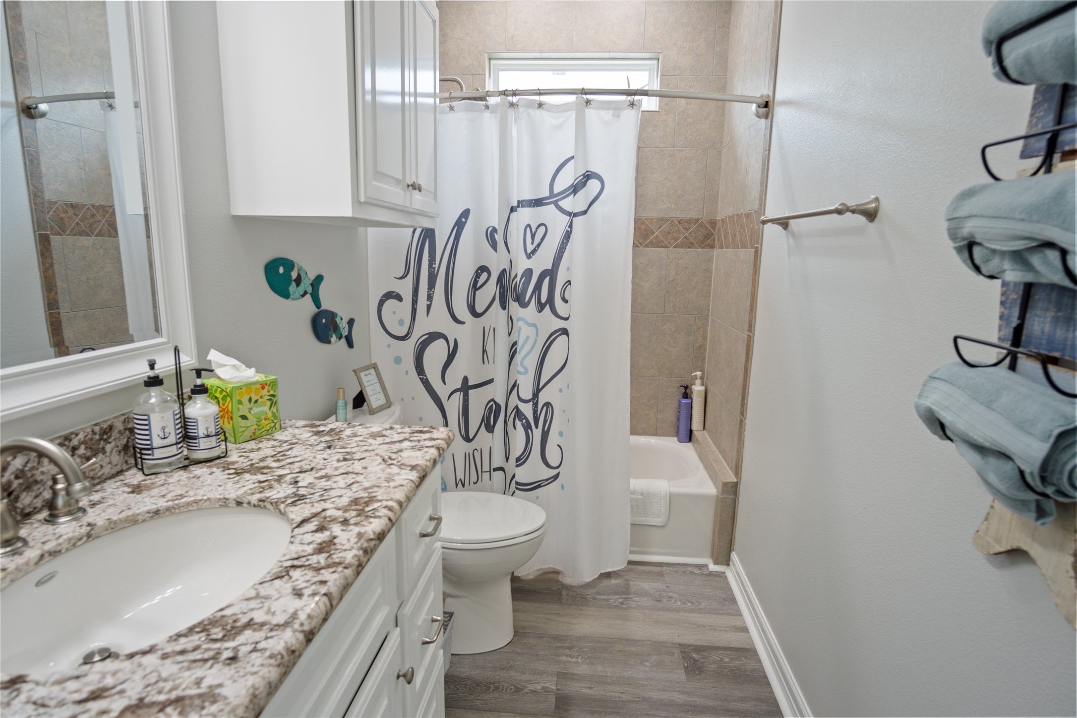 956 Biscayne Crystal Beach, TX 77650 - Photo 24 of 46 a bathroom with a granite countertop sink a toilet and shower
