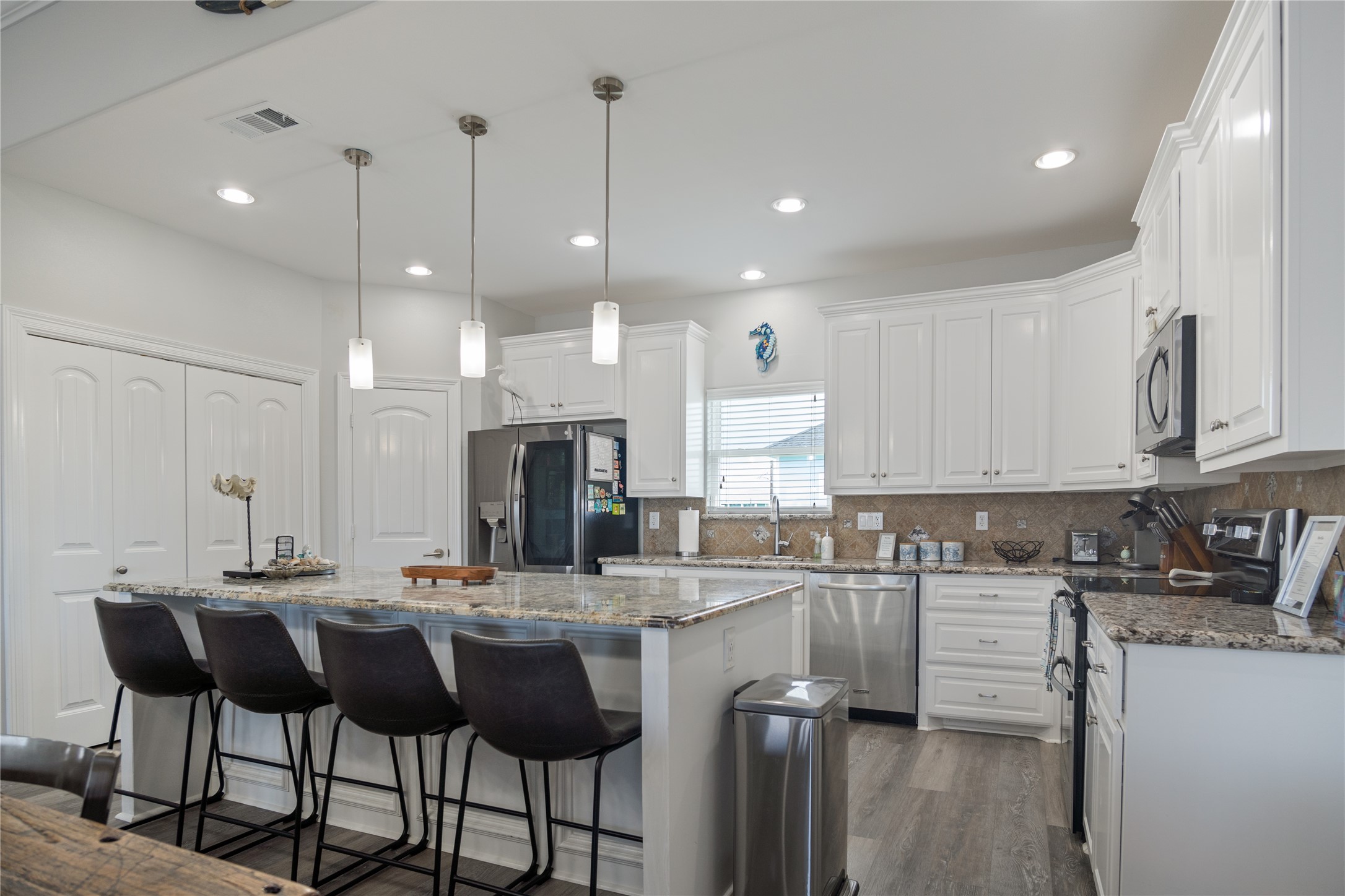 956 Biscayne Crystal Beach, TX 77650 - Photo 4 of 46 a kitchen with a dining table chairs sink and cabinets