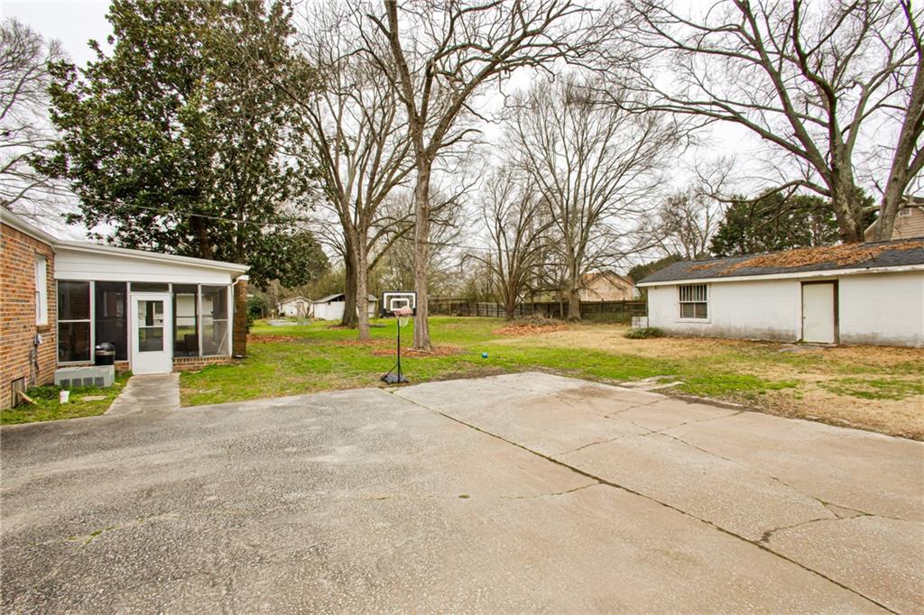 2880 Old Lost Mountain Road, Unit A Powder Springs, GA 30127 - Photo 16 of 23 a view of a house with a backyard and a tree