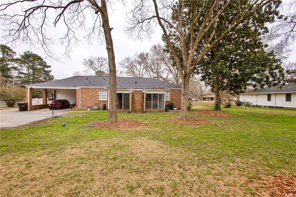2880 Old Lost Mountain Road, Unit A Powder Springs, GA 30127 - Photo 17 of 23 a front view of a house with a garden and trees