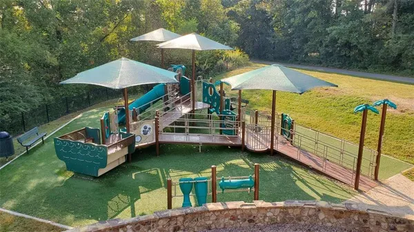 a view of a house with swimming pool and sitting area