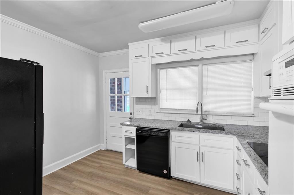 2880 Old Lost Mountain Road, Unit A Powder Springs, GA 30127 - Photo 4 of 23 a kitchen with stainless steel appliances granite countertop a stove and a refrigerator