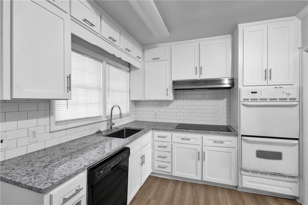 2880 Old Lost Mountain Road, Unit A Powder Springs, GA 30127 - Photo 6 of 23 a kitchen with granite countertop white cabinets and white appliances
