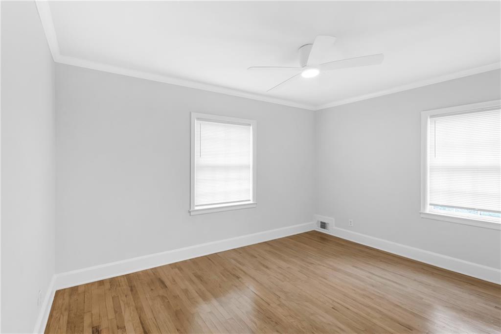 2880 Old Lost Mountain Road, Unit A Powder Springs, GA 30127 - Photo 7 of 23 an empty room with wooden floor and windows