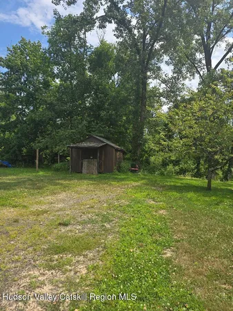 a backyard of a house with table and chairs