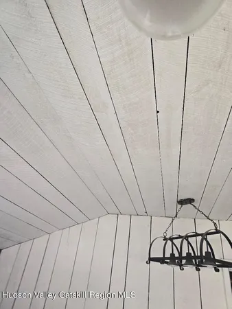 a view of a refrigerator in an empty room