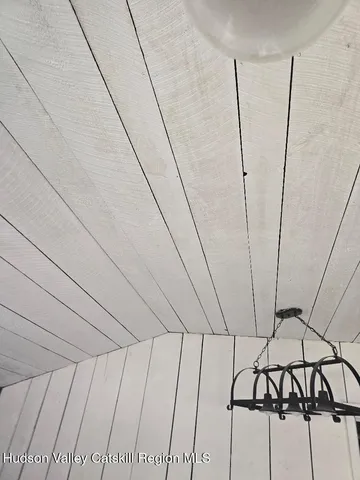 a view of a refrigerator in an empty room