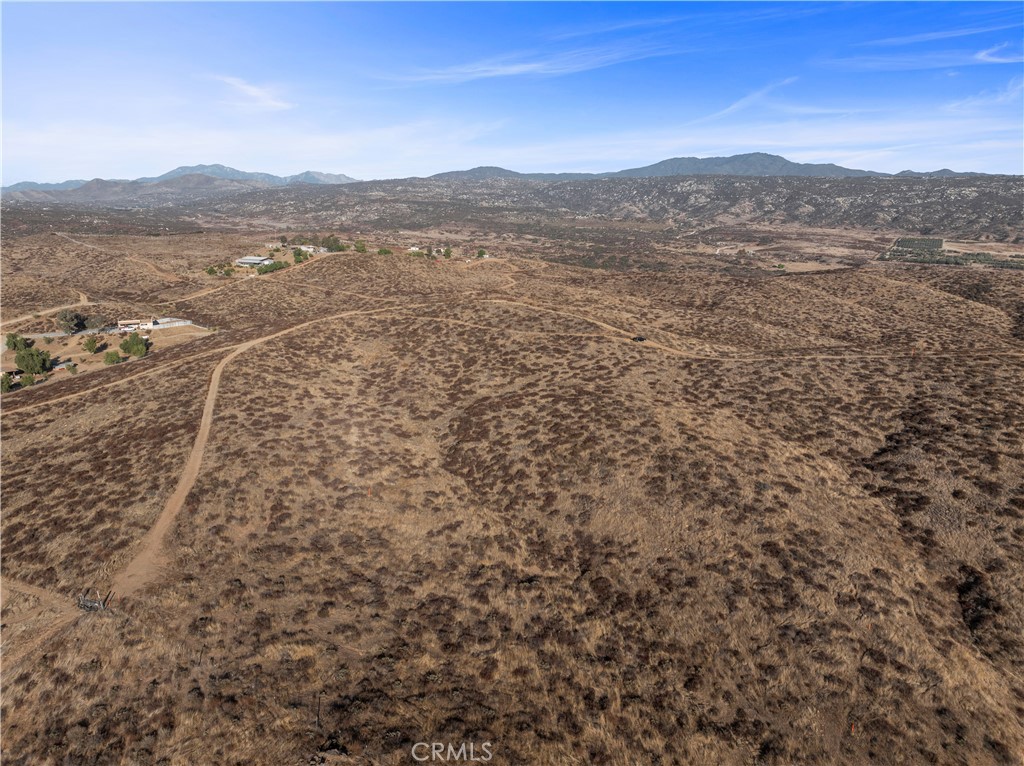 0 San Ignacio Road Hemet, CA 92544 - Photo 9 of 13 a view of a dry yard with mountains in the background