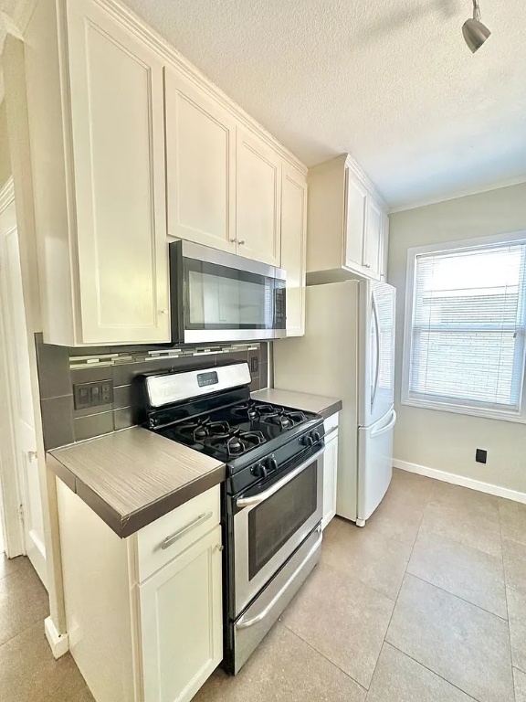 2712 Windsor Road Austin, TX 78703 - Photo 2 of 10 a kitchen with granite countertop a sink stove and refrigerator