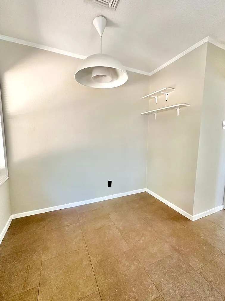 2712 Windsor Road Austin, TX 78703 - Photo 6 of 10 Spare room with crown molding and baseboards