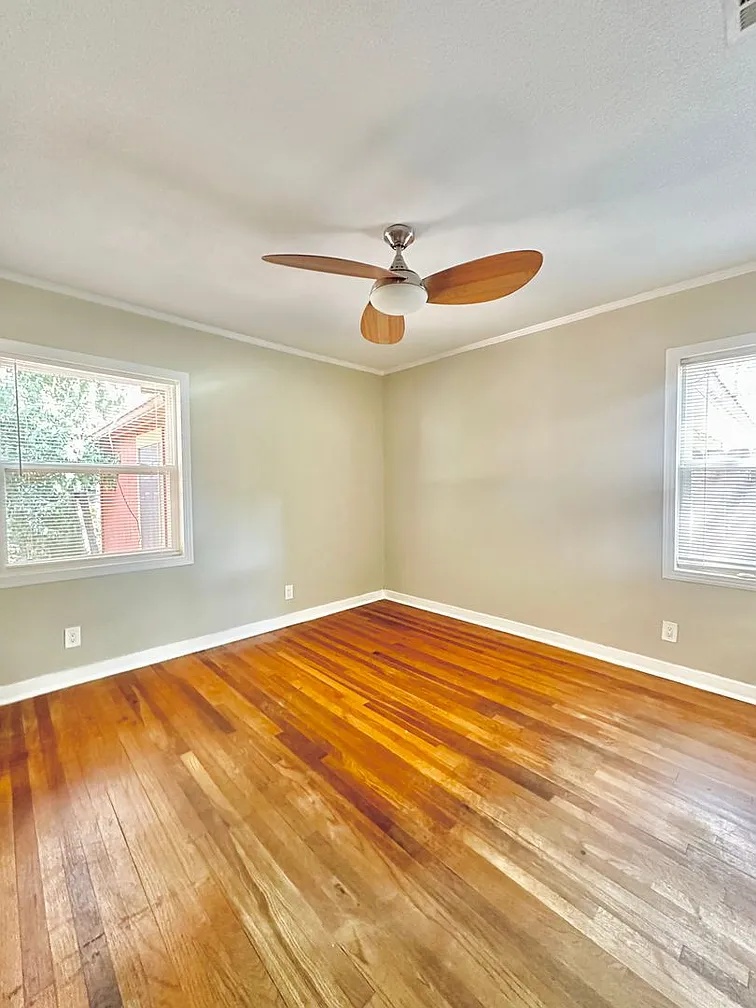2712 Windsor Road Austin, TX 78703 - Photo 7 of 10 Unfurnished room featuring light wood-type flooring, crown molding, and ceiling fan