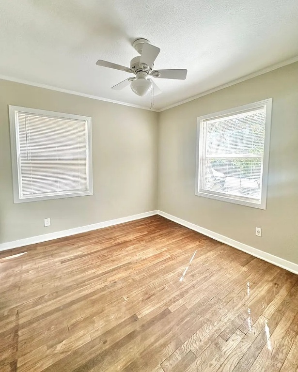 2712 Windsor Road Austin, TX 78703 - Photo 10 of 10 a view of an empty room with wooden floor and a window