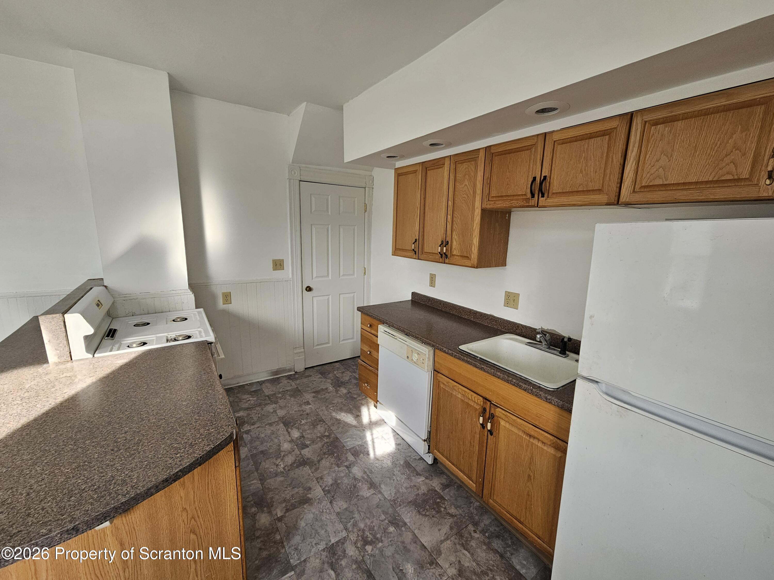 1044 John Avenue Scranton, PA 18510 - Photo 15 of 28 a kitchen with stainless steel appliances granite countertop a sink stove and cabinets