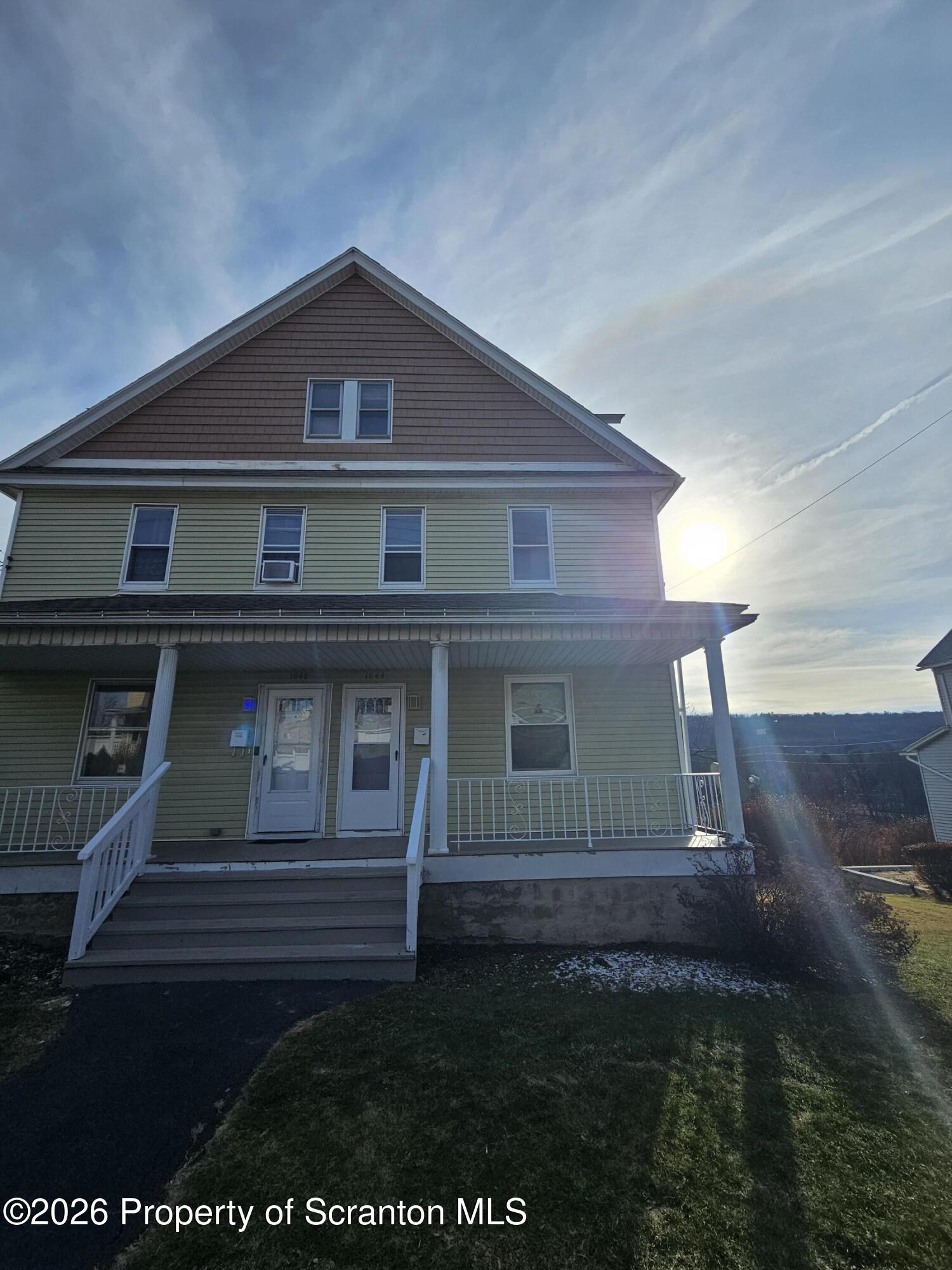 1044 John Avenue Scranton, PA 18510 - Photo 2 of 28 a front view of a house with a yard
