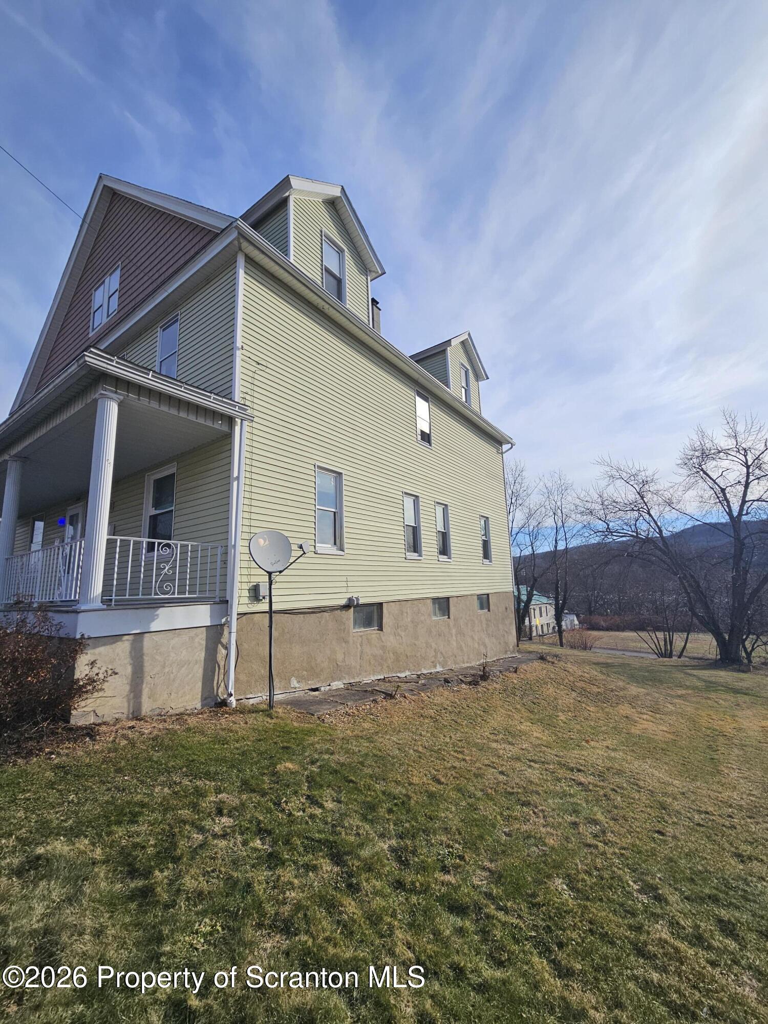 1044 John Avenue Scranton, PA 18510 - Photo 3 of 28 a view of a house with a yard
