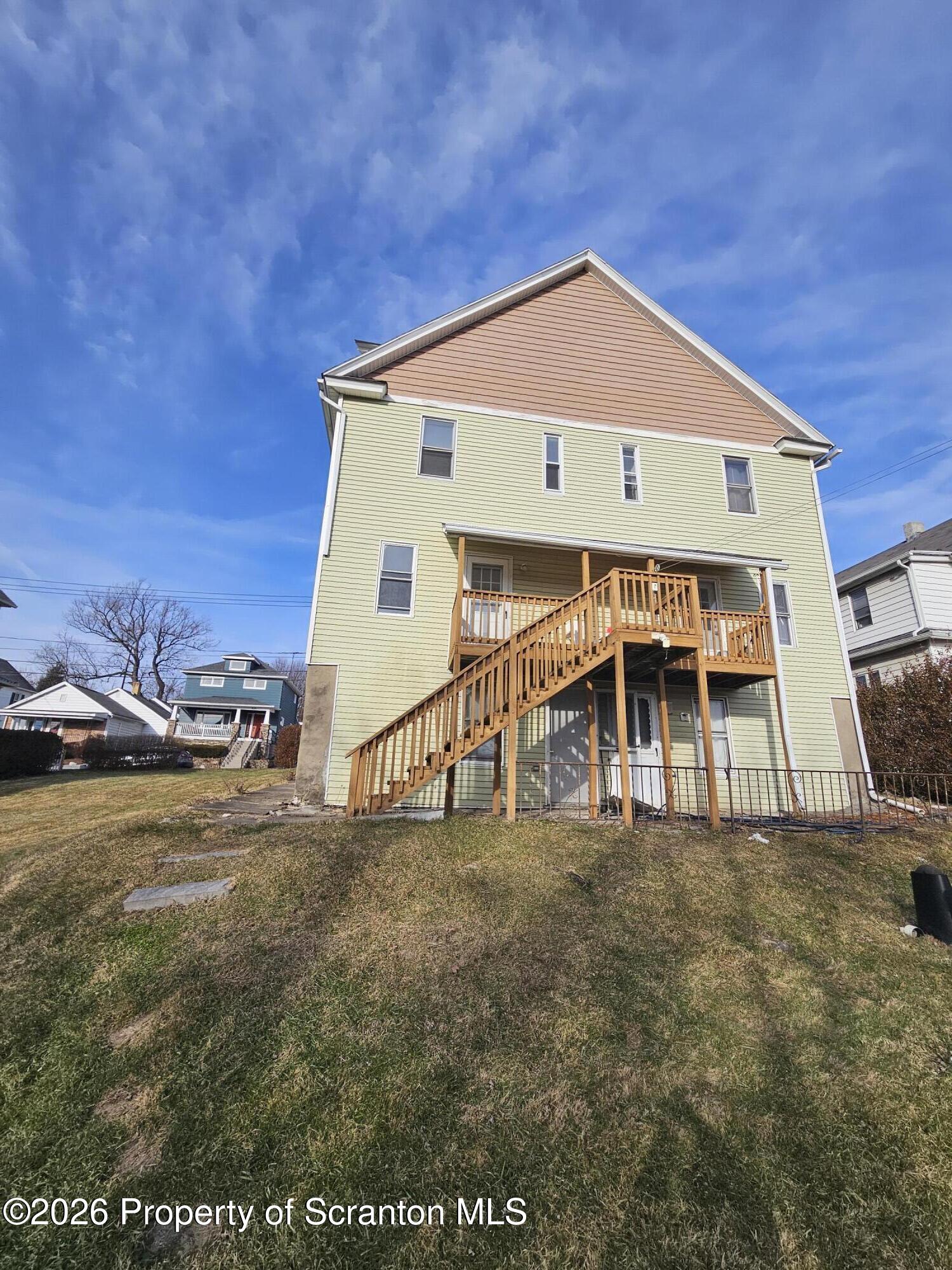 1044 John Avenue Scranton, PA 18510 - Photo 4 of 28 a front view of a house with a yard