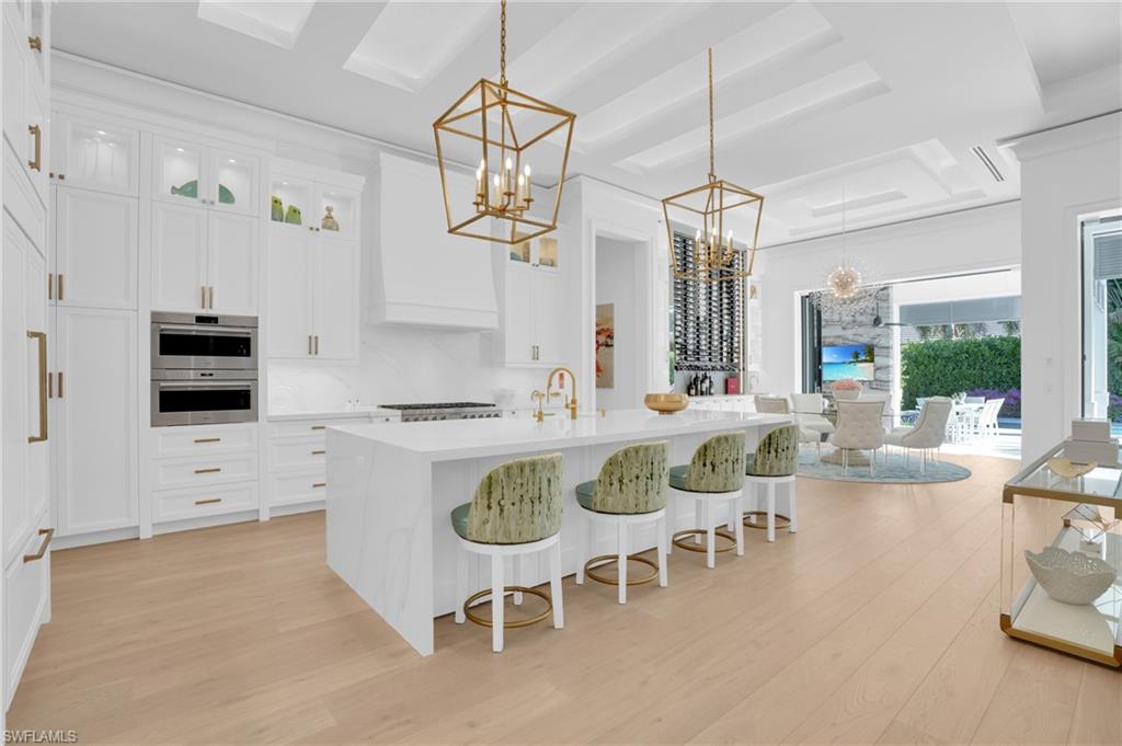 3110 Leeward Lane Naples, FL 34103 - Photo 11 of 50 a large kitchen with a table and chairs