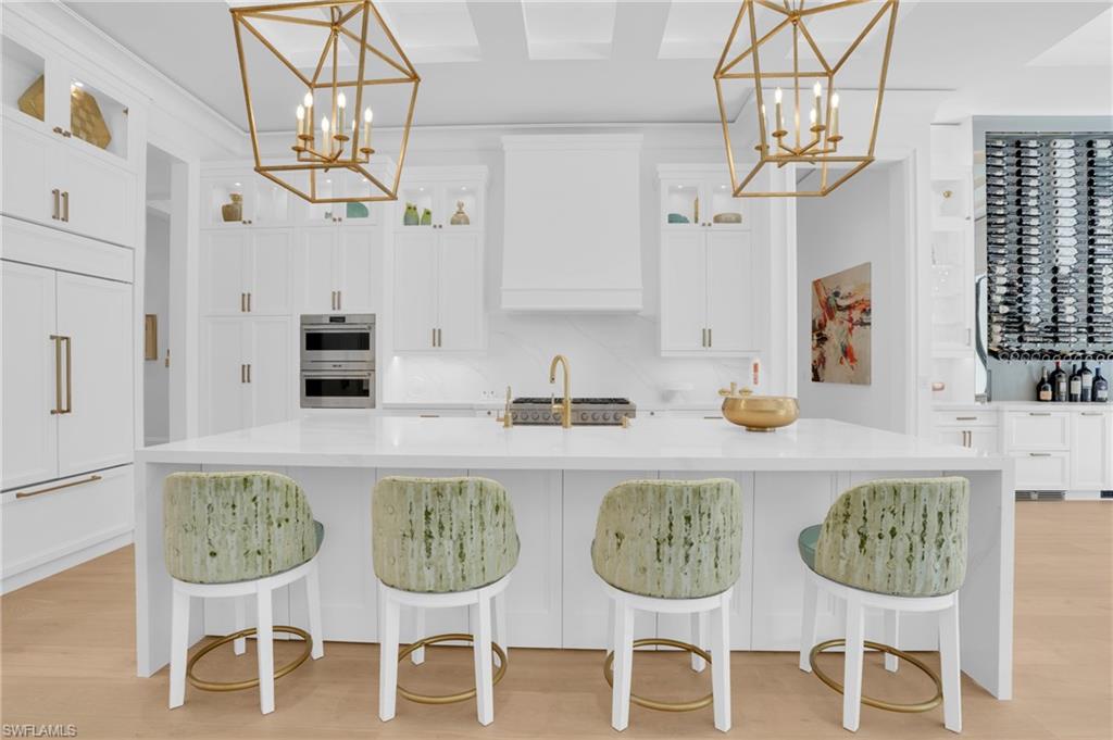 3110 Leeward Lane Naples, FL 34103 - Photo 13 of 50 a kitchen with a dining table and chairs in it