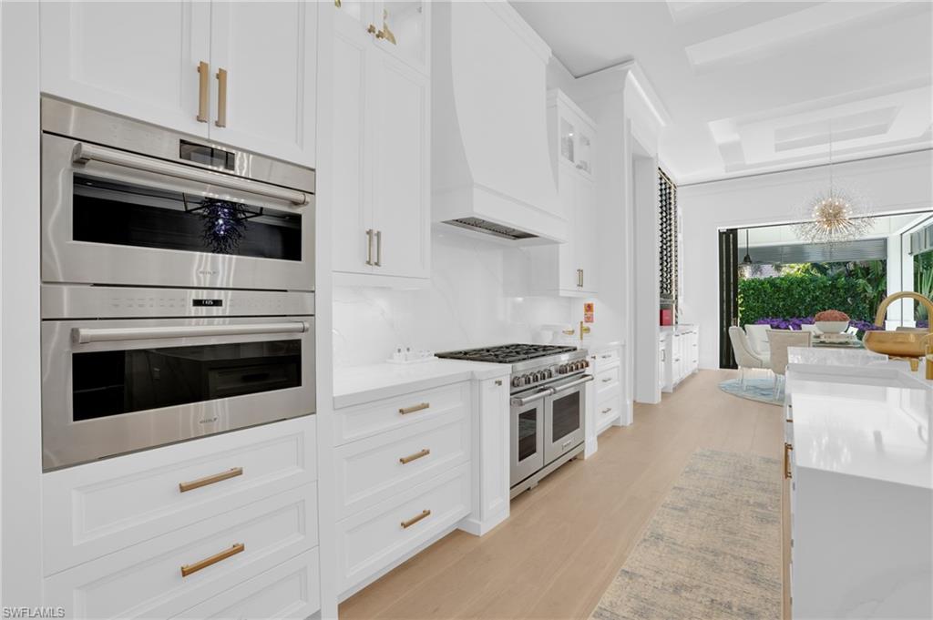 3110 Leeward Lane Naples, FL 34103 - Photo 14 of 50 a kitchen with stainless steel appliances white cabinets and a stove