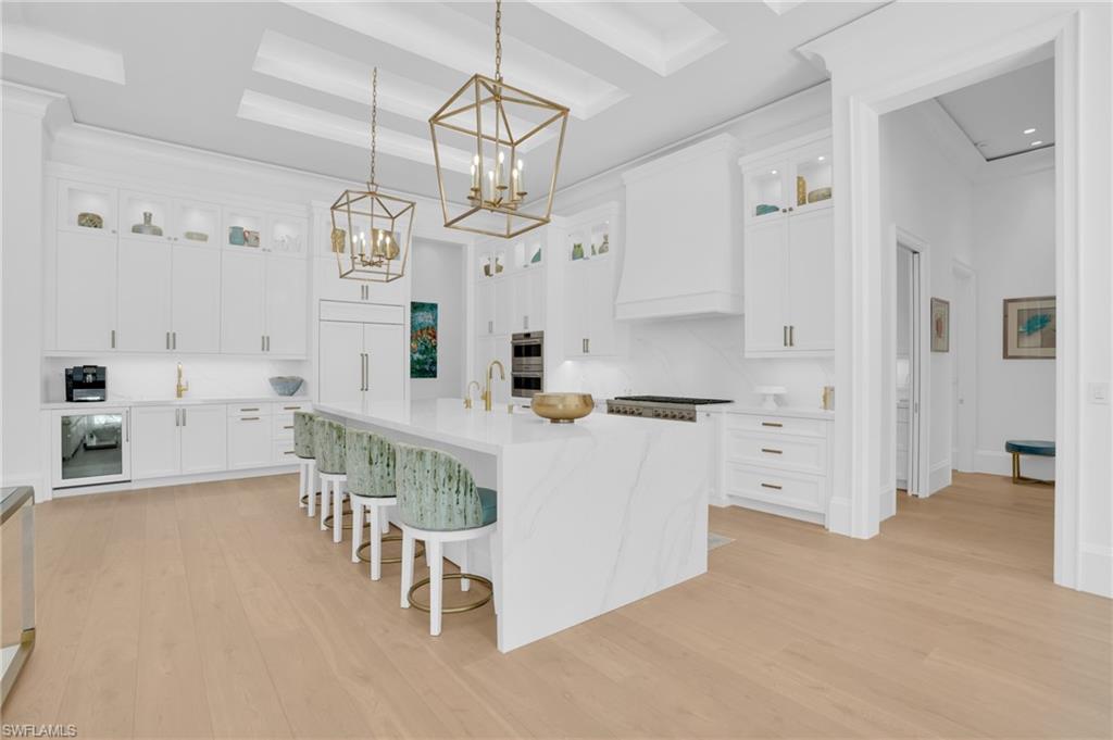 3110 Leeward Lane Naples, FL 34103 - Photo 15 of 50 a large white kitchen with lots of counter space and stainless steel appliances