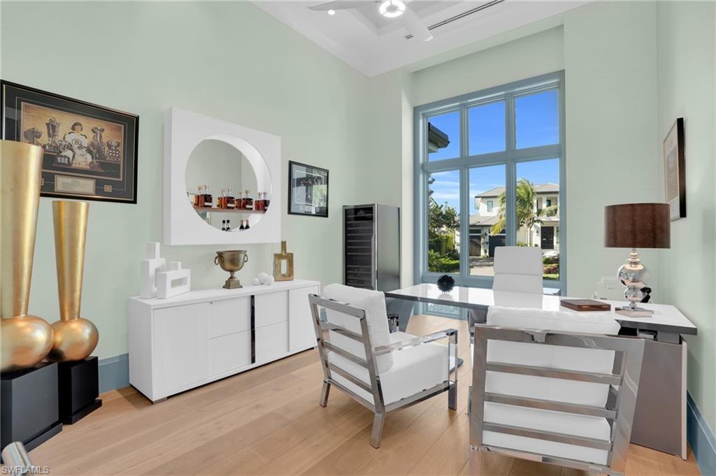 3110 Leeward Lane Naples, FL 34103 - Photo 19 of 50 a living room with furniture and a flat screen tv