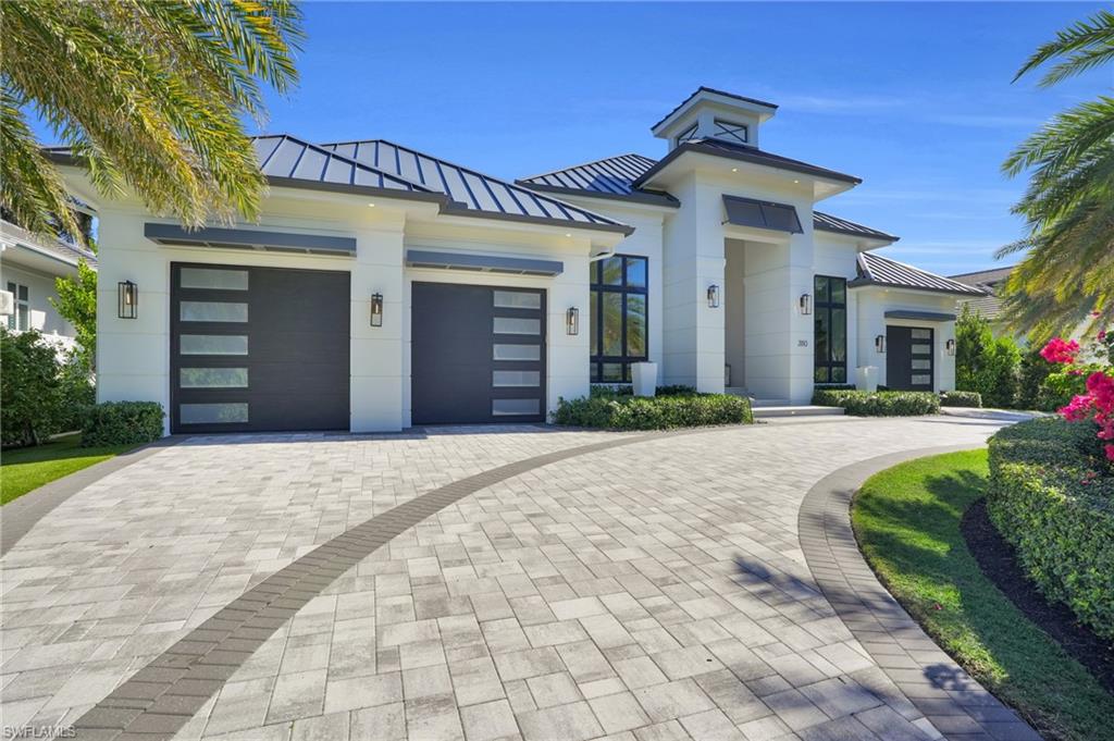 3110 Leeward Lane Naples, FL 34103 - Photo 2 of 50 a front view of a house with a yard