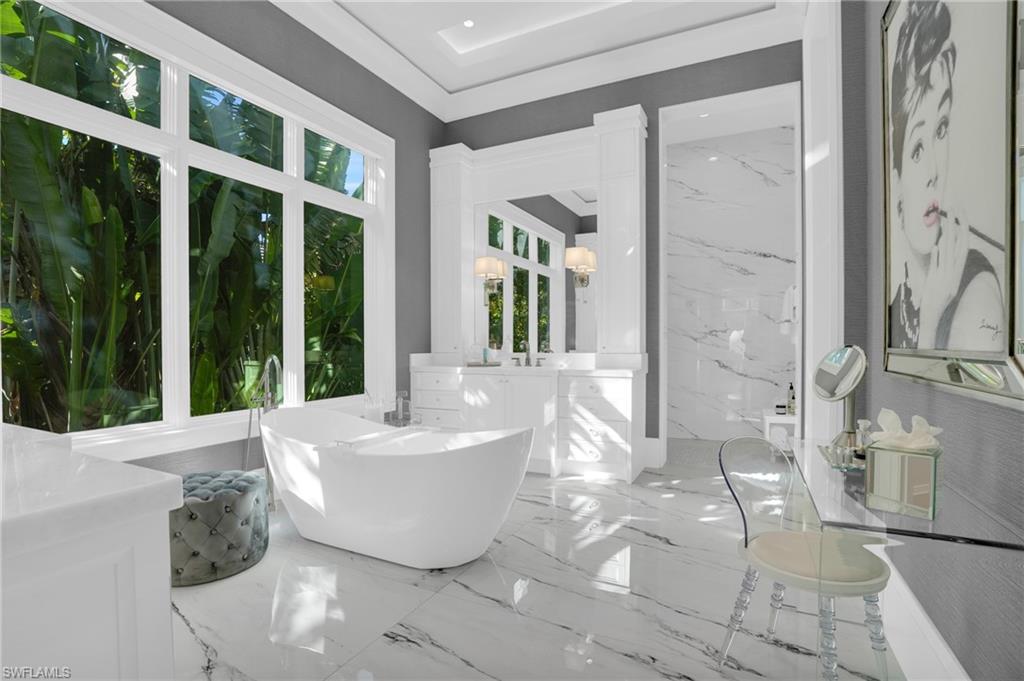 3110 Leeward Lane Naples, FL 34103 - Photo 22 of 50 a spacious bathroom with a bathtub and shower