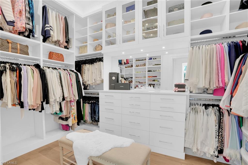 3110 Leeward Lane Naples, FL 34103 - Photo 23 of 50 a view of walk in closet with clothes and shoes