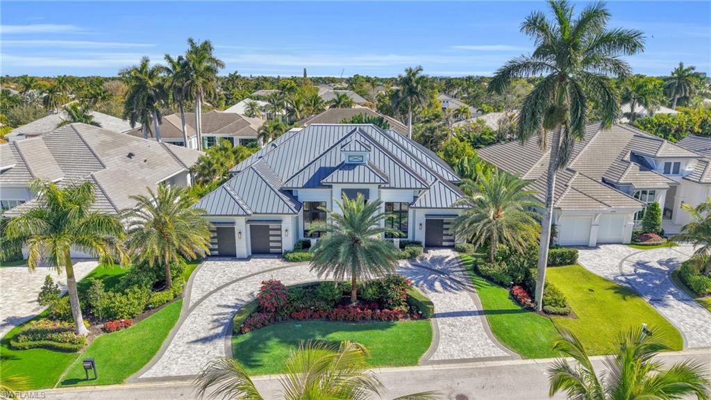 3110 Leeward Lane Naples, FL 34103 - Photo 3 of 50 a front view of a house with a garden