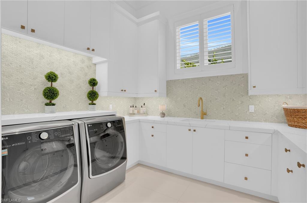 3110 Leeward Lane Naples, FL 34103 - Photo 31 of 50 a utility room with cabinets washer and dryer
