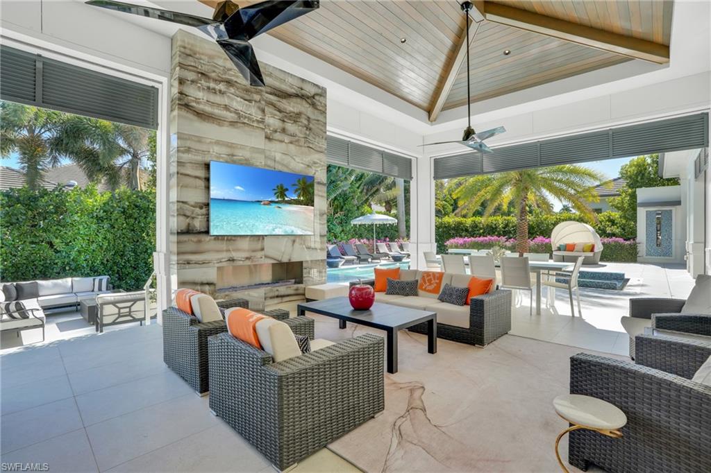 3110 Leeward Lane Naples, FL 34103 - Photo 37 of 50 a outdoor space with patio couch and a fireplace