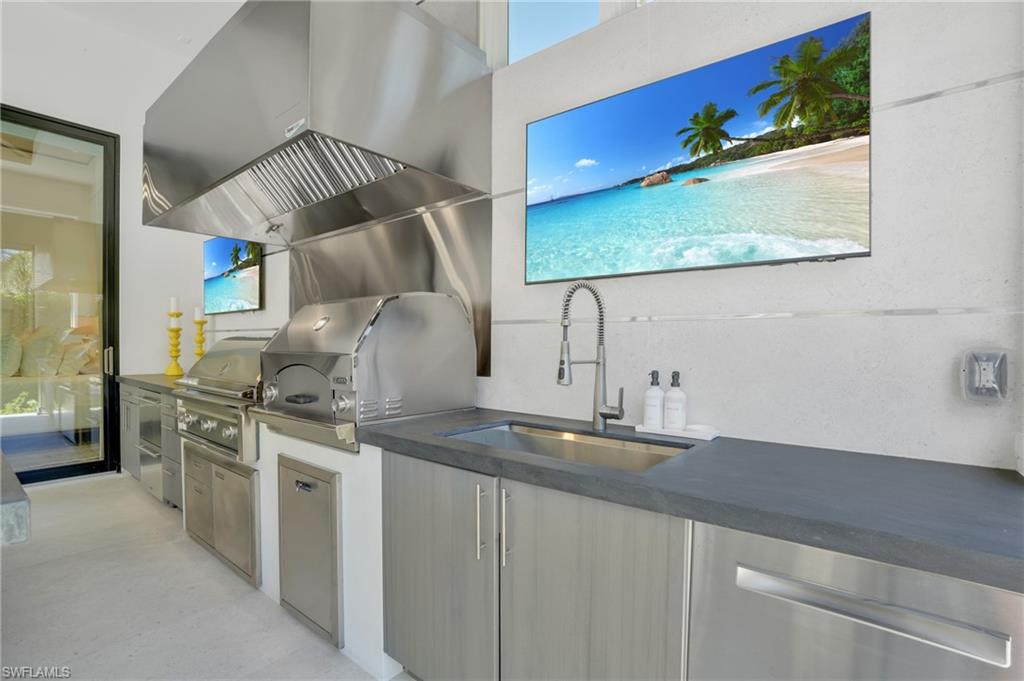 3110 Leeward Lane Naples, FL 34103 - Photo 39 of 50 a kitchen with stainless steel appliances granite countertop a sink and a stove