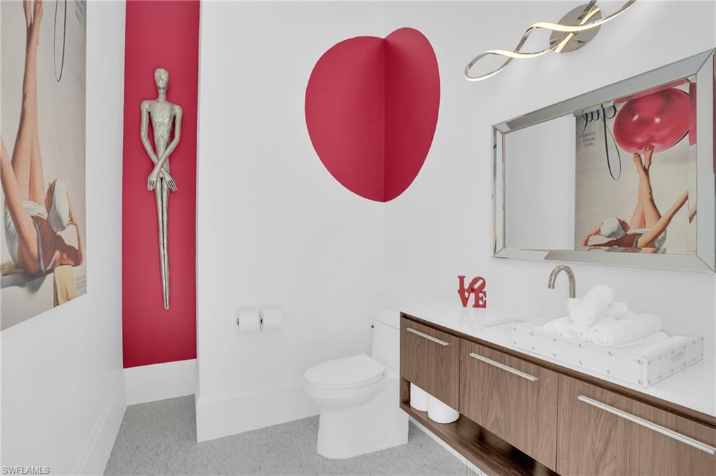 3110 Leeward Lane Naples, FL 34103 - Photo 41 of 50 a bathroom with a sink mirror vanity and toilet