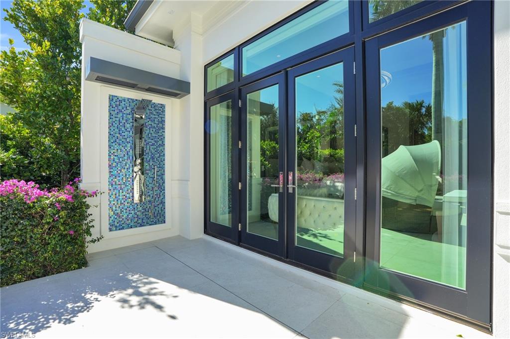 3110 Leeward Lane Naples, FL 34103 - Photo 43 of 50 a front view of a house with a porch