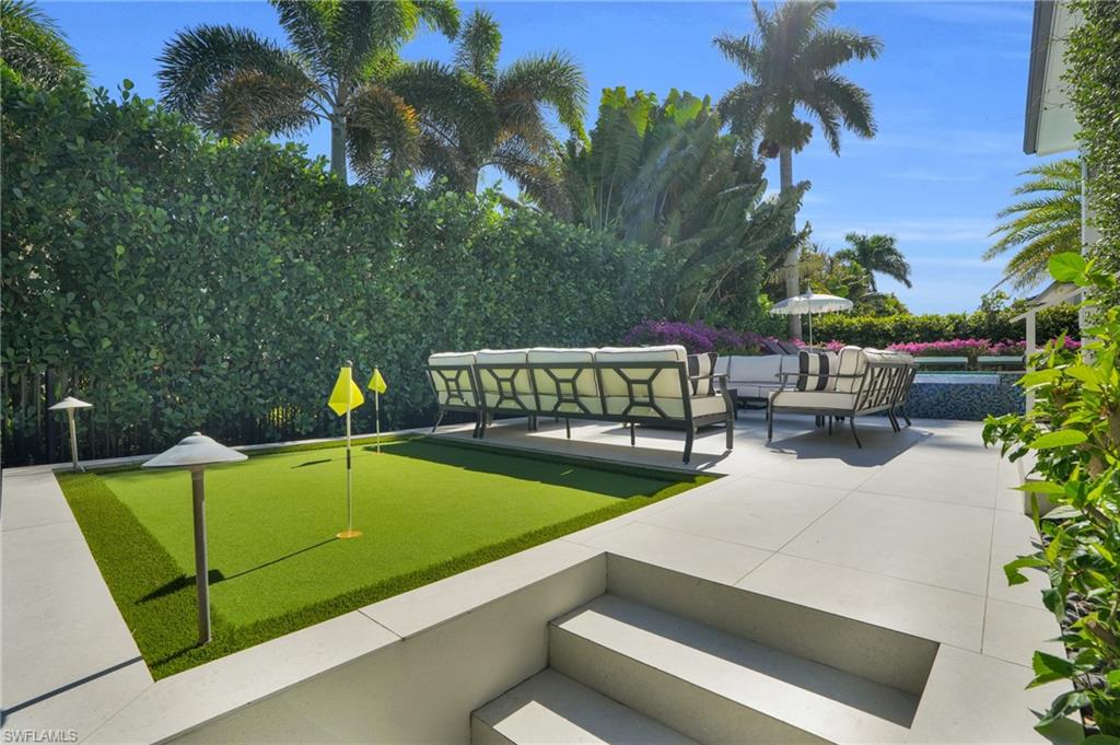 3110 Leeward Lane Naples, FL 34103 - Photo 45 of 50 a view of a swimming pool with chairs